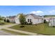 Inviting one-story home with mature landscaping, healthy green lawn, and a paved driveway at 119 Yadkin St, Clayton, NC 27520