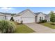 One-story home with attached garage, concrete driveway, well-manicured lawn, and appealing landscaping at 119 Yadkin St, Clayton, NC 27520