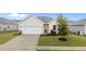 Charming one-story home featuring a well-maintained lawn, concrete driveway, and attached garage at 119 Yadkin St, Clayton, NC 27520