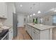 Spacious kitchen featuring stainless appliances and large granite island at 119 Yadkin St, Clayton, NC 27520