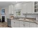 Kitchen featuring granite counters, stainless dishwasher, and ample cabinet space at 119 Yadkin St, Clayton, NC 27520
