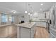 Open kitchen with granite counters, island, and stainless steel appliances at 119 Yadkin St, Clayton, NC 27520