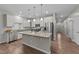 Bright kitchen featuring granite countertops, white cabinetry, and a spacious island at 119 Yadkin St, Clayton, NC 27520