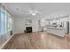Open living room featuring a fireplace and stainless steel appliances in an adjacent kitchen at 119 Yadkin St, Clayton, NC 27520