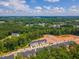 Aerial view featuring townhomes surrounded by lush greenery and forest, and community roads for ease of access at 1359 Chowan Ave, Durham, NC 27713