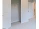 Unfinished bedroom closet features a single wire shelf and a light-colored carpet at 1359 Chowan Ave, Durham, NC 27713