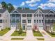 New townhomes with colorful front doors, single car garages, and manicured lawns are move in ready at 1359 Chowan Ave, Durham, NC 27713