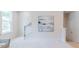 Upstairs hallway with staircase and decorative wall art and light-filled landing area at 1359 Chowan Ave, Durham, NC 27713