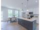 Modern kitchen featuring a center island, white cabinets and stainless steel appliances at 1359 Chowan Ave, Durham, NC 27713