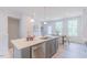 Kitchen island featuring a stainless steel dishwasher and sink with bar stool seating at 1359 Chowan Ave, Durham, NC 27713