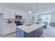 Modern kitchen features stainless steel appliances, a center island with seating, and bright countertops at 1359 Chowan Ave, Durham, NC 27713