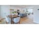 Bright kitchen with white cabinets, stainless appliances, large island and wood floors at 1359 Chowan Ave, Durham, NC 27713