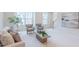 Bright living room with a sofa, chairs, and a view of the staircase and artwork at 1359 Chowan Ave, Durham, NC 27713