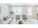 Inviting living room showcasing a comfortable sofa and two armchairs with views through large windows at 1359 Chowan Ave, Durham, NC 27713