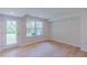 Bright living room with light wood floors, a door to the outside, and lots of natural light at 1359 Chowan Ave, Durham, NC 27713