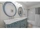 Bathroom vanity with double sinks and mirrors, and a shower/tub combo at 136 Garden Retreat Dr, Garner, NC 27529