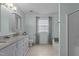 Ensuite bathroom featuring double sinks, tiled flooring, and a separate shower and tub at 136 Garden Retreat Dr, Garner, NC 27529