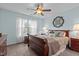Bedroom with neutral walls, carpeted floors, a wood bed frame and matching bedside tables at 136 Garden Retreat Dr, Garner, NC 27529