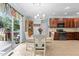 Bright dining area with stylish chandelier, wood table, and access to outdoor deck at 136 Garden Retreat Dr, Garner, NC 27529