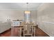 Bright dining space illuminated by chandelier, showcasing dining table, with wood floors at 136 Garden Retreat Dr, Garner, NC 27529