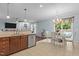Open-concept kitchen with an island, stainless steel appliances, and seamlessly connects to dining and living at 136 Garden Retreat Dr, Garner, NC 27529