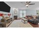 Comfortable living room featuring a fireplace, hardwood floors, and a ceiling fan at 136 Garden Retreat Dr, Garner, NC 27529