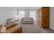 Bright living room featuring carpeted floors, a pair of sofas, and natural light from the windows at 136 Garden Retreat Dr, Garner, NC 27529