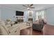 Comfortable living room with a fireplace, hardwood floors, and ample natural light at 136 Garden Retreat Dr, Garner, NC 27529