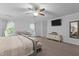 Spacious main bedroom features a ceiling fan, TV, sitting area, and ensuite bathroom at 136 Garden Retreat Dr, Garner, NC 27529