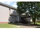 Back exterior showing screened in porch, vinyl siding, mature tree, and green lawn at 136 Wedgewood Ct, Sanford, NC 27332