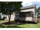 Exterior rear of home featuring a tan vinyl, screened porch, and spacious backyard at 136 Wedgewood Ct, Sanford, NC 27332