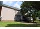 Spacious backyard with lush green grass and mature trees, showing back of house and covered porch at 136 Wedgewood Ct, Sanford, NC 27332
