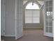 Bedroom showcasing carpet, neutral walls, a window with blinds, and a doorway with glass doors at 136 Wedgewood Ct, Sanford, NC 27332
