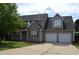 Charming home with a two car garage, manicured lawn and a mature tree, partly cloudy sky at 136 Wedgewood Ct, Sanford, NC 27332