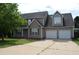 Charming two-story home with a two car garage and manicured lawn and a mature tree at 136 Wedgewood Ct, Sanford, NC 27332