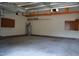 Spacious two car garage featuring concrete floors, storage shelving, and a water heater at 136 Wedgewood Ct, Sanford, NC 27332