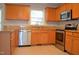 Well-lit kitchen featuring wood cabinets, stainless steel appliances, and granite countertops at 136 Wedgewood Ct, Sanford, NC 27332