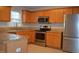 Modern kitchen with wooden cabinets, stainless steel appliances, and granite countertops at 136 Wedgewood Ct, Sanford, NC 27332