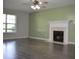 Open living room features modern flooring, a ceiling fan, and fireplace at 136 Wedgewood Ct, Sanford, NC 27332