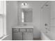 Well-lit bathroom with a large mirror, modern vanity, and a shower-tub combination at 1414 Arena Ln, Fuquay Varina, NC 27526