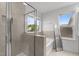 Bright bathroom with large tub, glass shower door and window with views at 1414 Arena Ln, Fuquay Varina, NC 27526