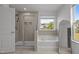 Bathroom featuring shower with glass door, tub and large window at 1414 Arena Ln, Fuquay Varina, NC 27526