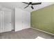 Bedroom featuring a paneled accent wall, ceiling fan, and multiple doorways at 1414 Arena Ln, Fuquay Varina, NC 27526