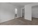 Carpeted bedroom featuring multiple doorways, neutral walls, and natural light at 1414 Arena Ln, Fuquay Varina, NC 27526