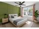 Charming bedroom with an accent wall, large window, and a comfortable bed with neutral bedding at 1414 Arena Ln, Fuquay Varina, NC 27526
