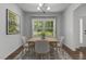 Cozy dining room featuring a square table with four chairs and a bright window view at 1414 Arena Ln, Fuquay Varina, NC 27526
