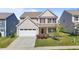 Charming two-story home featuring a well-manicured lawn and a welcoming front porch at 1414 Arena Ln, Fuquay Varina, NC 27526