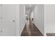 Bright hallway with hardwood floors leading to a sunlit window at the far end at 1414 Arena Ln, Fuquay Varina, NC 27526