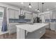 Bright kitchen featuring a large island, stainless steel appliances, and modern pendant lighting at 1414 Arena Ln, Fuquay Varina, NC 27526