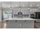Spacious kitchen showcasing a large island with modern pendant lights and stainless steel appliances at 1414 Arena Ln, Fuquay Varina, NC 27526